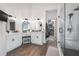 Bathroom featuring dual vanities, a glass-enclosed shower, and access to a walk-in closet at 5015 Preservation Pointe Nw, Kennesaw, GA 30152