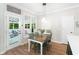 Bright breakfast nook with seating, a window overlooking a screened-in porch and backyard at 5015 Preservation Pointe Nw, Kennesaw, GA 30152
