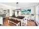 Bright dining room with dark wood table, bench, and buffet underneath a modern light fixture at 5015 Preservation Pointe Nw, Kennesaw, GA 30152