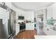 Well-lit kitchen with white cabinets, stainless steel appliances, and views into the dining area is perfect for cooking at 5015 Preservation Pointe Nw, Kennesaw, GA 30152