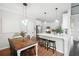 Eat-in kitchen featuring barstool seating, stainless appliances, and open access to the dining area at 5015 Preservation Pointe Nw, Kennesaw, GA 30152