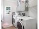 Functional laundry room with washer, dryer, and storage cabinets offers convenience and organization at 5015 Preservation Pointe Nw, Kennesaw, GA 30152