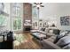 Spacious living room with floor-to-ceiling fireplace, lots of natural light and comfortable seating at 5015 Preservation Pointe Nw, Kennesaw, GA 30152