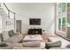 Cozy living room featuring a beautiful stone fireplace and lots of natural light at 5015 Preservation Pointe Nw, Kennesaw, GA 30152