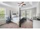 Serene bedroom with a four-poster bed, tray ceiling, and bay window offers a peaceful retreat at 5015 Preservation Pointe Nw, Kennesaw, GA 30152