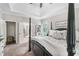 Spacious bedroom featuring a four-poster bed, tray ceiling, and neutral decor at 5015 Preservation Pointe Nw, Kennesaw, GA 30152