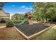 A wooden playground with climbing wall, slide, and swing in a mulched play area at 5015 Preservation Pointe Nw, Kennesaw, GA 30152