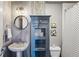 Charming bathroom featuring a pedestal sink, updated fixtures, and unique storage cabinet for toiletries at 3180 Mathieson Ne Dr # 1001, Atlanta, GA 30305