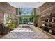 Stylish building lobby with brick walls, tile floors, seating, and views of the outdoors at 3180 Mathieson Ne Dr # 1001, Atlanta, GA 30305
