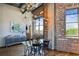 Dining area features modern lighting, exposed brick, hardwood floors and exposed ductwork at 3180 Mathieson Ne Dr # 1001, Atlanta, GA 30305