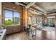 Dining room with modern lighting, exposed brick, open layout, and hardwood floors at 3180 Mathieson Ne Dr # 1001, Atlanta, GA 30305