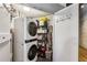 Efficient laundry area with stacked washer/dryer and storage shelving, perfect for organized living at 3180 Mathieson Ne Dr # 1001, Atlanta, GA 30305