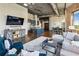 Spacious open-concept living area with a modern kitchen, exposed brick, and comfortable seating arrangement at 3180 Mathieson Ne Dr # 1001, Atlanta, GA 30305