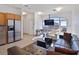 Modern condo living room featuring a TV, hardwood floors and a stainless steel refrigerator at 3180 Mathieson Ne Dr # 1001, Atlanta, GA 30305