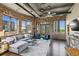 Bright living room features exposed brick, ductwork, and large windows with a cityscape view at 3180 Mathieson Ne Dr # 1001, Atlanta, GA 30305