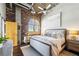 Well-lit main bedroom showcasing exposed brick, a large window and stylish contemporary furniture at 3180 Mathieson Ne Dr # 1001, Atlanta, GA 30305