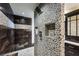 Luxurious shower featuring pebble tile design and modern fixtures at 3180 Mathieson Ne Dr # 1001, Atlanta, GA 30305