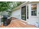 Charming covered back porch with a grill, perfect for outdoor cooking and relaxation, with a deck and nearby lawn at 4140 Summit Dr, Marietta, GA 30068