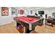Basement features a red pool table under bright lights in this rec space with comfortable seating and room to entertain at 4140 Summit Dr, Marietta, GA 30068