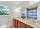 Bright bathroom with double vanity, large mirror, and window offering natural light with a separate shower with blue striped curtain at 4140 Summit Dr, Marietta, GA 30068