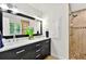 Modern bathroom features a double sink vanity with marble countertop and a separate glass-enclosed shower with tiled walls at 4140 Summit Dr, Marietta, GA 30068