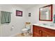 Cozy bathroom featuring a wood-trimmed mirror and a clean, tiled floor at 4140 Summit Dr, Marietta, GA 30068
