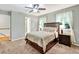 Comfortable bedroom with a ceiling fan, a large window, and ensuite bathroom, featuring neutral color tones at 4140 Summit Dr, Marietta, GA 30068