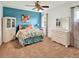 Cozy bedroom with blue accent wall, decorative bedding, and ample storage with a dresser and display cabinet at 4140 Summit Dr, Marietta, GA 30068