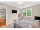 This bedroom is a serene escape, offering a bed, guitar, mounted TV and a view of the outdoors through its bright window at 4140 Summit Dr, Marietta, GA 30068