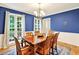 Elegant dining room with hardwood floors, a wooden table, and natural light from large windows at 4140 Summit Dr, Marietta, GA 30068