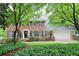 Charming two-story brick home with a manicured lawn, black shutters, and mature trees providing shade at 4140 Summit Dr, Marietta, GA 30068