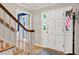 Light-filled foyer with hardwood floors, staircase, coat rack, and white trim at 4140 Summit Dr, Marietta, GA 30068