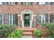 Close-up of front entrance featuring brick steps, flower wreath, and decorative sidelights at 4140 Summit Dr, Marietta, GA 30068