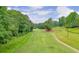 Lush green golf course view, lined with trees and a clear blue sky, perfect for golf enthusiasts at 4140 Summit Dr, Marietta, GA 30068