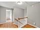 Upstairs hallway with hardwood flooring, stairs, and doors leading to other rooms, with access to the attic at 4140 Summit Dr, Marietta, GA 30068