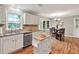 Bright eat-in kitchen with white cabinets, stainless steel appliances, and hardwood floors at 4140 Summit Dr, Marietta, GA 30068