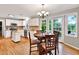 Bright eat-in kitchen with white cabinets, stainless appliances, island, and outdoor access at 4140 Summit Dr, Marietta, GA 30068