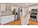 Fully-equipped kitchen featuring stainless appliances, center island and hardwood floors at 4140 Summit Dr, Marietta, GA 30068
