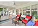 Cozy sunroom with ceiling fan, bright windows, and comfortable seating with colorful pillows, perfect for relaxation at 4140 Summit Dr, Marietta, GA 30068