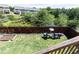 Backyard featuring well-maintained lawn, garden bed, pond and fenced perimeter at 5888 Cobblestone Creek Cir, Mableton, GA 30126