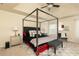 Comfortable main bedroom with a four-poster bed, decorative pillows, ceiling fan, and bench seat at 5888 Cobblestone Creek Cir, Mableton, GA 30126