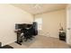 Functional bedroom setup as a home office with desk, monitors and comfortable gaming chair, well lit by a ceiling fan and natural light at 5888 Cobblestone Creek Cir, Mableton, GA 30126