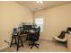 Cozy bedroom setup as a home office with desk, monitors and a comfortable chair, well lit by a ceiling fan and natural light at 5888 Cobblestone Creek Cir, Mableton, GA 30126