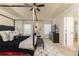 Comfortable main bedroom with a four-poster bed, decorative pillows, ceiling fan, and an en-suite bathroom at 5888 Cobblestone Creek Cir, Mableton, GA 30126