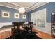 Chic dining room with blue walls, modern lighting, tray ceilings, and elegant decor at 5888 Cobblestone Creek Cir, Mableton, GA 30126