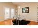 Bright dining area with a glass table, modern chairs, and doors leading to the outside at 5888 Cobblestone Creek Cir, Mableton, GA 30126