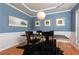 Chic dining room with blue walls, modern lighting, tray ceilings, and elegant decor at 5888 Cobblestone Creek Cir, Mableton, GA 30126