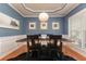 Chic dining room with blue walls, modern lighting, tray ceilings, and elegant decor at 5888 Cobblestone Creek Cir, Mableton, GA 30126