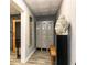 Hallway with lockers, bench, tile floor and Buddha head statue at 5888 Cobblestone Creek Cir, Mableton, GA 30126