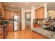 Well-equipped kitchen with stainless steel appliances, wood cabinets, and granite countertops at 5888 Cobblestone Creek Cir, Mableton, GA 30126